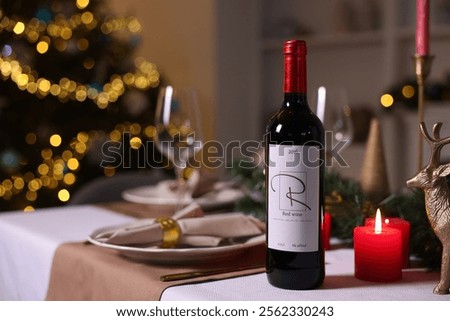 Festive table setting with dishware, wine and decor indoors