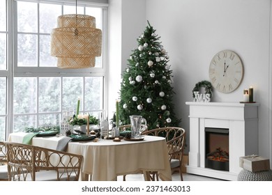 Festive table setting in living room with Christmas tree and fireplace - Powered by Shutterstock