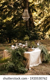 Festive table for two in the forest. Banquet table. Presidium for newlyweds. . High quality photo