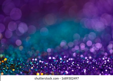 Festive twinkle lights background, abstract sparkle backdrop with circles,modern design wallpaper with sparkling glimmers. Blue, purple and green backdrop glittering sparks with glow effect