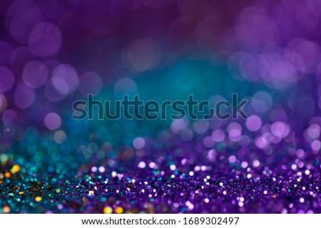 Festive twinkle lights background, abstract sparkle backdrop with circles,modern design wallpaper with sparkling glimmers. Blue, purple and green backdrop glittering sparks with glow effect