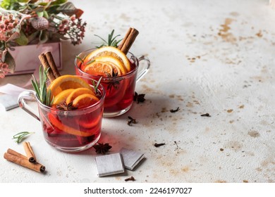Festive valentines composition with mulled wine, spices, flowers, sweets and gift on white textured background with space for text. Valentine' s day surprize for lover or romantic dinner. Horisontal 