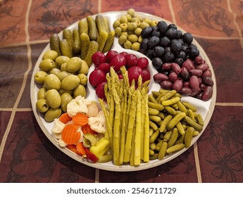 Festive vegetable platter with colorful peppers, cucumbers, radishes, carrots, cherry tomatoes, and creamy dips in bell pepper bowls. Perfect for Thanksgiving, Christmas, or holiday celebrations. - Powered by Shutterstock