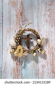 Festive Willow Wreath With Eggs, Cross And Decorative Angel On Rustic Wooden Background. Easter, Palm Sunday Holiday. Prayer, Faith, Spiritual Life, Orthodox Church, Religion Concept. Flat Lay