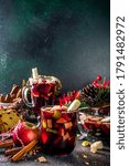 Festive winter fruit punch or sangria drink. Christmas mulled red wine. Ponche de frutas Navideño cocktail, Mexian Christmas hot  beverage with sugar cane and fruit, hot sweet liquor wine drink