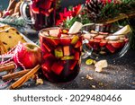 Festive winter fruit punch or sangria drink. Christmas mulled red wine. Ponche de frutas Navideño cocktail, Mexian Christmas hot  beverage with sugar cane and fruit, hot sweet liquor wine drink