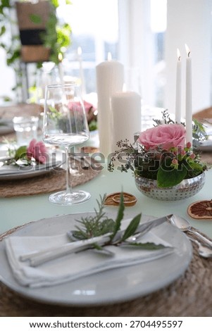 A festively set table for a wedding dinner. Tastefully decorated restaurant background with short depth of field.