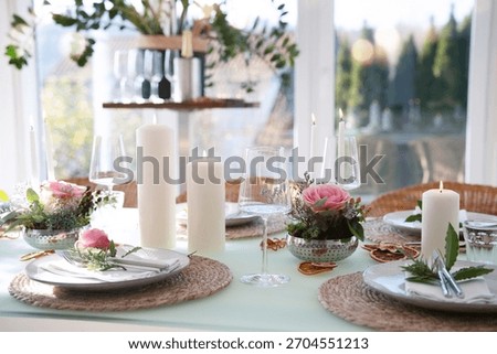A festively set table for a wedding dinner. Tastefully decorated restaurant background with short depth of field.