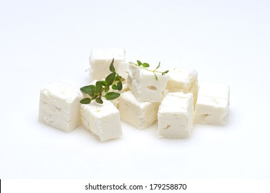 Feta Cheese Cubes And Oregano On A White Background