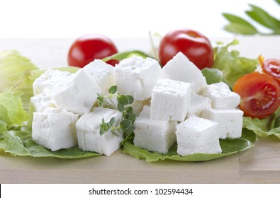 Feta Cheese Cut In Cubes, Vegetables, Herbs And Olive Oil-the Ingredients For A Greek Salad