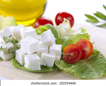 Feta Cheese Cut In Cubes, Vegetables, Herbs And Olive Oil-the Ingredients For A Greek Salad