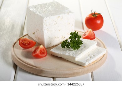 Feta Greek Cheese On Chopping Board White Background