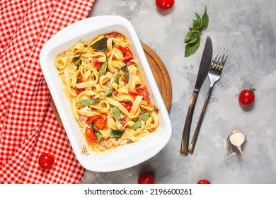 Fetapasta. Trending Viral Feta Bake Pasta Recipe Made Of Cherry Tomatoes, Feta Cheese, Garlic And Herbs In A Casserole Dish. Top View
