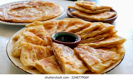 Feteer meshaltet - Feteer (Egyptian Pie), It consists of many thin layers of dough and ghee and an optional filling. The fillings can be both sweet or savory. - Shutterstock ID 2248779069