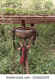 fetish used by Cameroonian farmers to deter bandits from entering their rooms!  this fetish consists of a clay calabash, an ox horn, an African braid and a red ribbon.