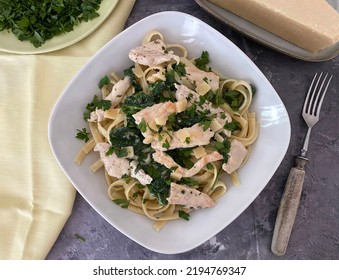 Fettuccine Alfredo With Pan Fried Chicken, Spinach Cheese Sauce And Parsley.