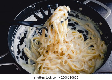 Fettuccine Alfredo In A Saute Pan: Freshly Made Noodles In A Creamy Parmesan Cheese Sauce