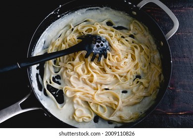 Fettuccine Alfredo In A Saute Pan: Freshly Made Noodles In A Creamy Parmesan Cheese Sauce