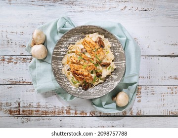 fettuccine Chicken Alfredo Pasta with Spinach in a Bowl top view. - Powered by Shutterstock