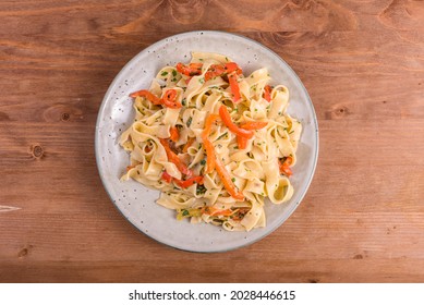 Fettuccine Pasta With Creamy Bell Pepper Sauce. Serving Of Italian Vegan Pasta On A Plate, Close-up, Overzu View