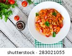 Fettuccine pasta with shrimp, tomatoes and herbs. Top view