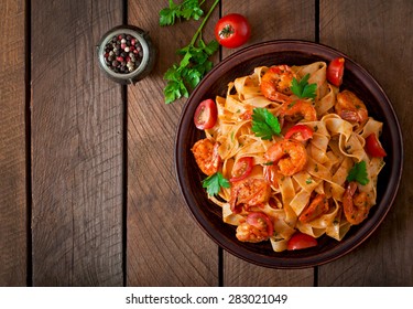 Fettuccine Pasta With Shrimp, Tomatoes And Herbs. Top View