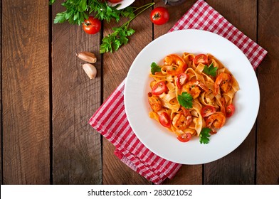 Fettuccine pasta with shrimp, tomatoes and herbs. Top view - Powered by Shutterstock