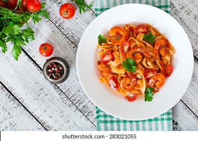 Fettuccine pasta with shrimp, tomatoes and herbs. Top view - Powered by Shutterstock