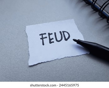 Feud writting on table background.