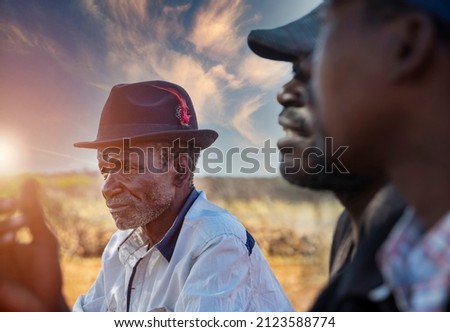 few African men communicating, father and son discussion in the village
