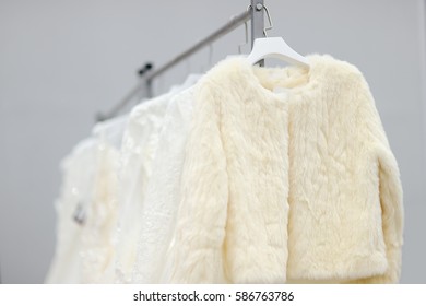 A Few Beautiful Wedding Dresses And Fur Coat On A Hanger. Bridal Shopping