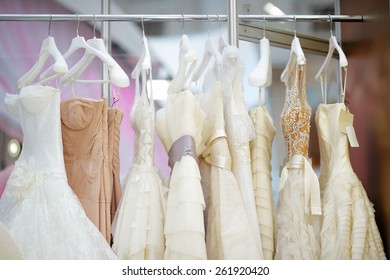 A few beautiful wedding dresses on a hanger  - Shutterstock ID 261920420
