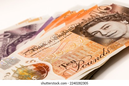 a few hundred pound of new GBP £ Sterling Twenty 20 and Ten 10 pound notes in a small fanned stack - Shutterstock ID 2240282305