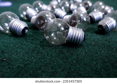 A few light bulbs scattered on the floor carpet. - Powered by Shutterstock