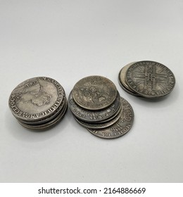 A Few Old Silver Coins In A Pile