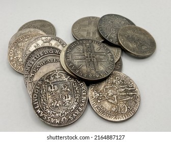 A Few Old Silver Coins In A Pile