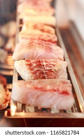 A Few Pieces Of Robalo Being Grilled