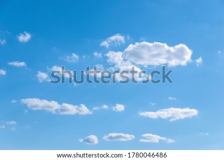 few random white clouds in blue sky, partly cloudiness