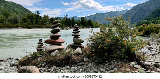 A few stacked stones near the river. Megaliths. Mountains - Shutterstock ID 2099870482