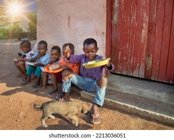 Few Village African Kids Eating In The Yard Puppy Trying To Steal The Food