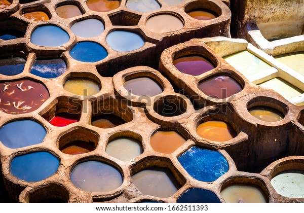 Fez is also famous for its\
old leather Tanneries. Old tanks of the Fez\'s tanneries with color\
paint for leather, Morocco, Africa. Artistic picture. Beauty\
world