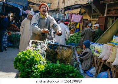 Fez, Morocco - March 8 2008 - A Vendor Pushing A Cart Full Of Green Vegetables Through In The Medina Of Fez. 