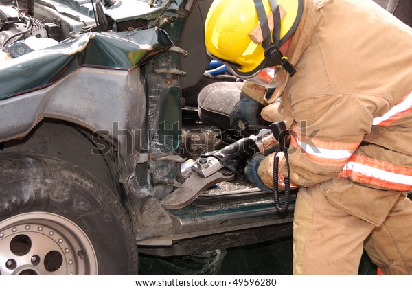 FF Making\
Dash Relief Cut before rolling the dash, Auto extrication drill  on\
a SUV with Roseburg OR Fire\
Dept.