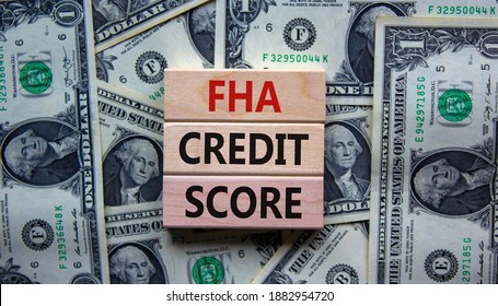 FHA credit score symbol. Concept words 'FHA credit score' on wooden blocks on a beautiful background from dollar bills. Business and FHA - federal housing administration credit score concept. - Shutterstock ID 1882954720