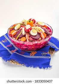 Fiambre  (traditional Guatemalan Family Dish Eaten On Nov 1, All Saints' Day / Day Of The Death), Mix Of Cold Cuts, Sausages, Vegetables. Served On A Guatemalan Textile, Isolated On White Background.