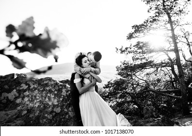 Fiance From Behind Hugs A Bride, A Walk In The Mountains In The Spring, Black And White Photo