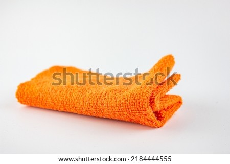 The Fiber cloth for cleaning. Rag for cleaning dust.Orange rag on a white background.