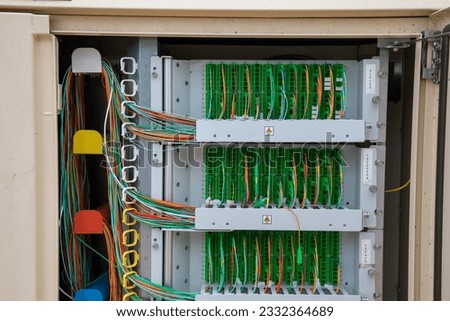 fiber communication inside outdoor neighborhood telecommunication junction box with binding posts and wires for DSL and telephone dial tones