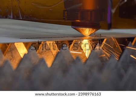 The fiber laser cutting machine  cut the metal plate with the sparkling light. The hi-technology sheet metal manufacturing process by laser cutting machine. 