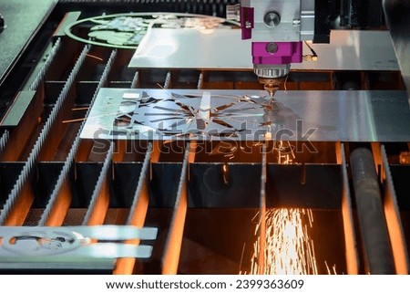 The fiber laser cutting machine  cut the metal plate with the sparkling light. The hi-technology sheet metal manufacturing process by laser cutting machine. 